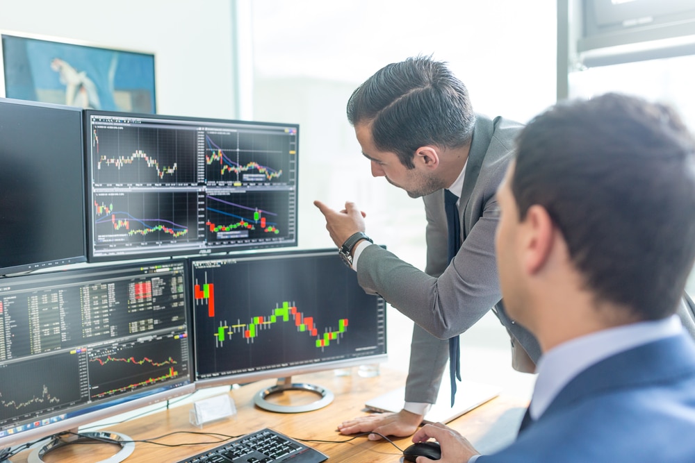BusinessmenTradingStocksOnlineStockBrokersLookingAtGraphsIndexes | Finserving